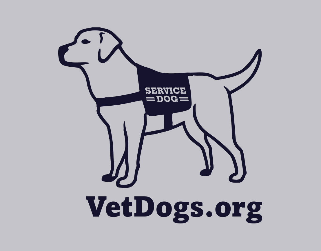 the image shows an up close shot of the service dog cartoon in a vest that is located on the back neck of the sweatshirt. Below the image is the text, "VetDogs.org" the image and text is in navy blue 