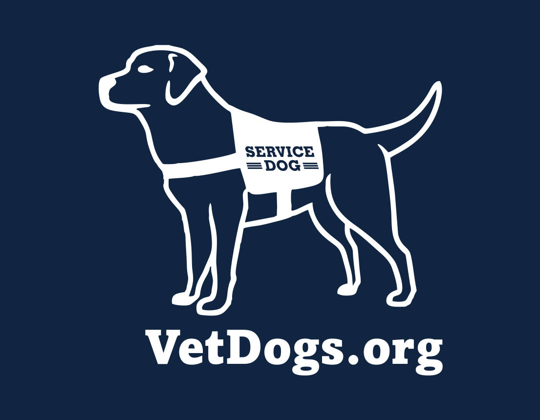 photos shows a cartoon image of a service dog. below this image is text that says, "VetDogs.org" This text and cartoon are white in color. this is the logo and image that is located on the bottom of the left sleeve.