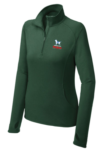 This image shows the America's VetDogs Women's Sport-Wick® Stretch 1/4-Zip Pullover in Forest Green, designed for active comfort and style. It features a smooth-faced fabric with a soft-brushed backing for warmth and moisture control. The pullover has a cadet collar with a chin guard, raglan sleeves for flexibility, and thumbholes to keep hands warm. A front pouch pocket provides added convenience, while the tag-free label, open cuffs, and hem offer a clean, streamlined look.